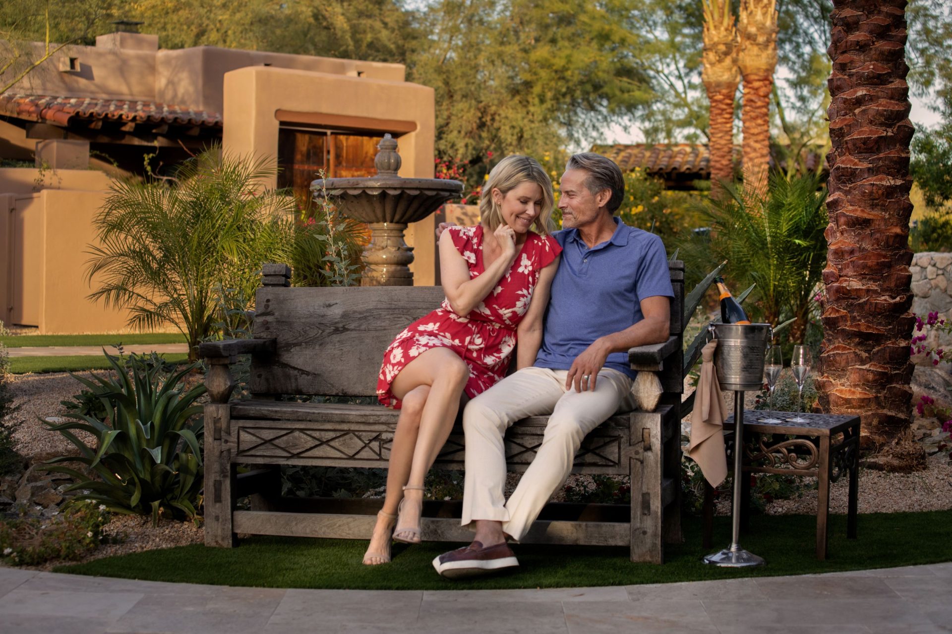 Couple enjoying romantic moment in garden of The Hermosa Inn.